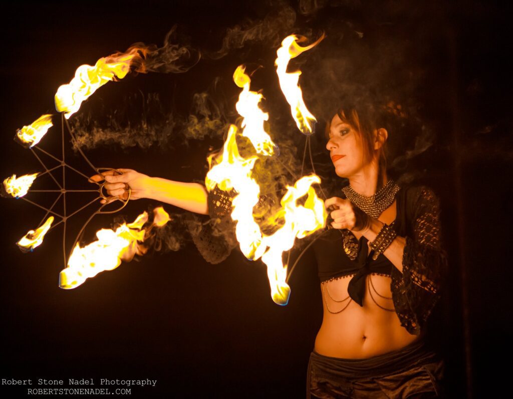 Fire Dancer performing with flaming fans